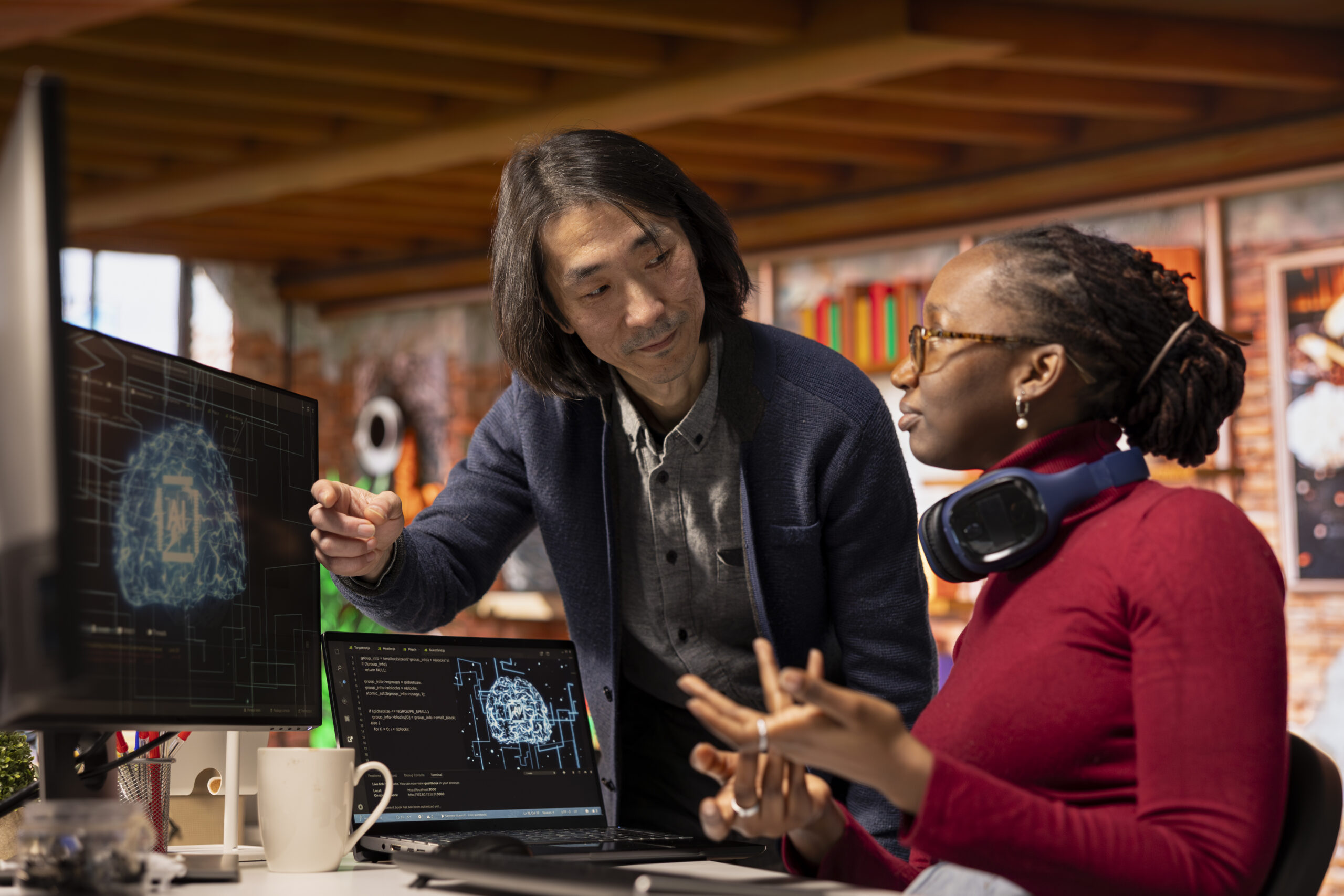 AI startup office chief technology officer overseeing programmer building application. Senior manager assisting worker in artificial intelligence software development agency, offering advice